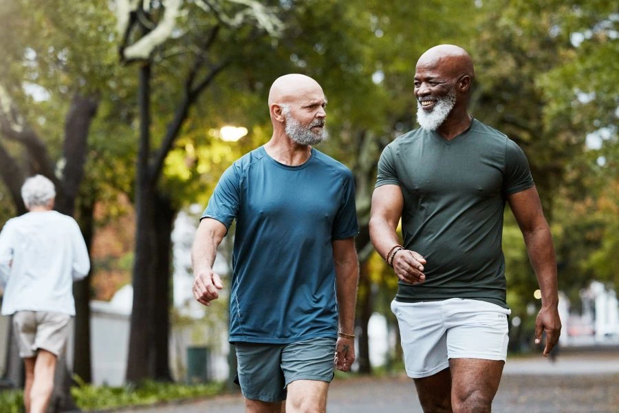 Two healthy senior men walking